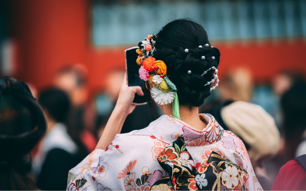 A Japanese woman in Kimono using her phone for Japan SNS