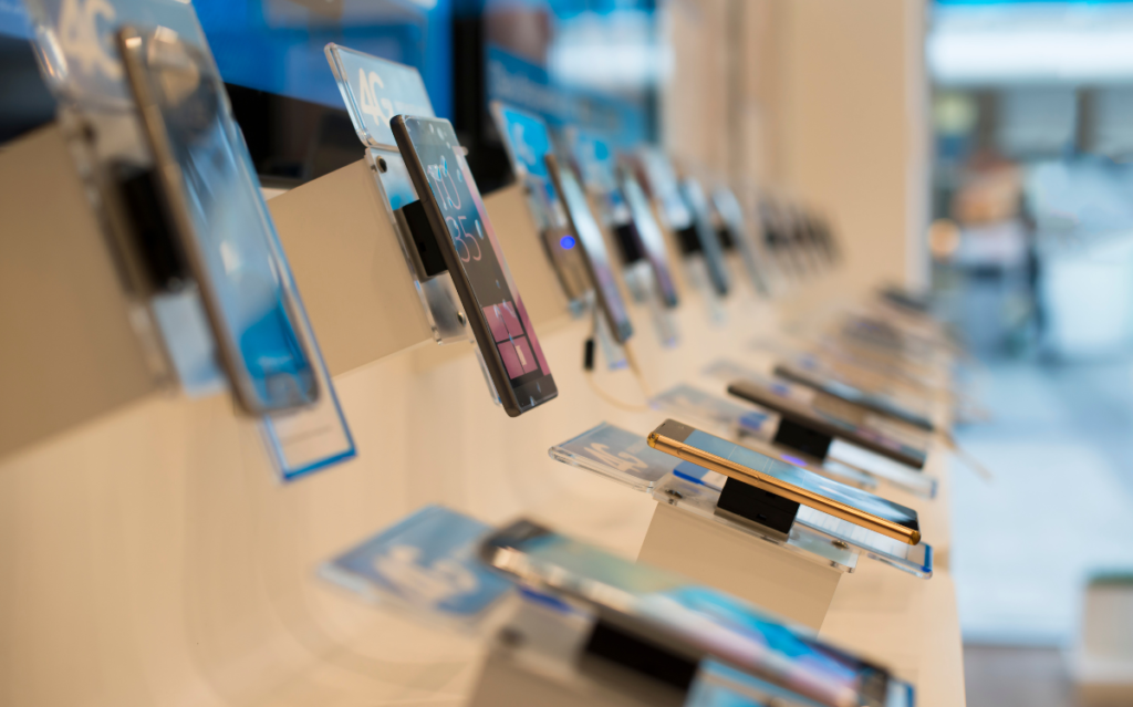 A line of new Apple & Samsung phones displayed in the store hinting new smartphone features 