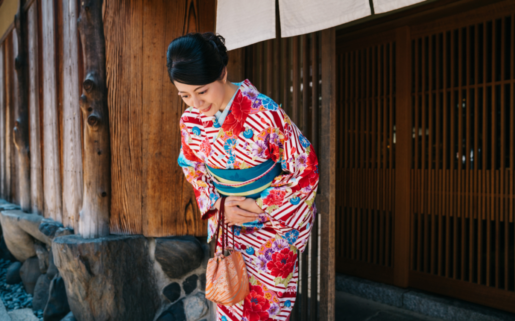 A Japanese woman bowing showing Japanese culture and how it can affect Japan marketing