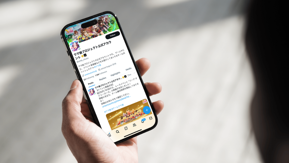 Japan mobile game X (Twitter) account on phone screen